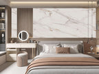 Modern bedroom with beige marble wall panels behind bed
