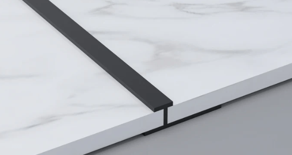 Black aluminum T trim installed between PVC marble sheets for clean joint and seamless panel finishing