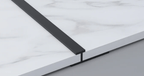 Black aluminum T trim installed between PVC marble sheets for clean joint and seamless panel finishing