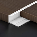 White aluminum wall panel trim end cap installed between wood panels, durable metal edge strip for clean panel edges and modern interior wall finishes