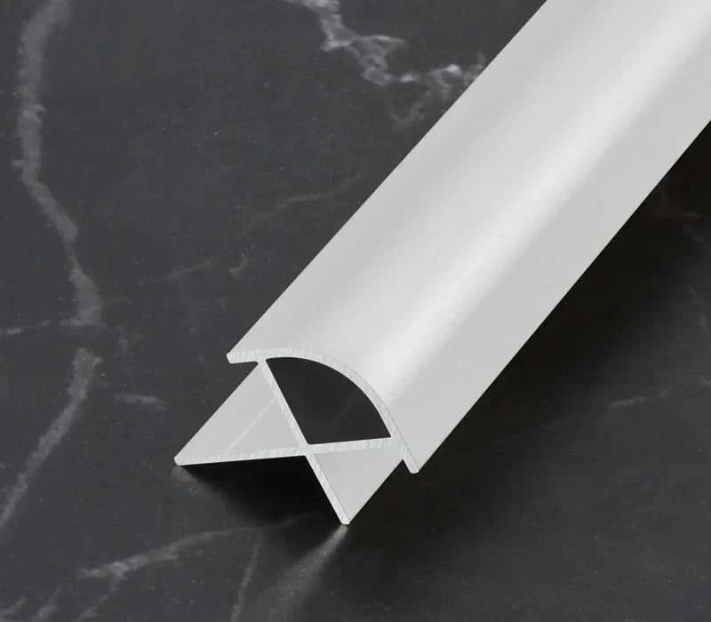 White aluminum wall panel outside corner trim with rounded profile, durable metal edge strip cross-section for clean modern wall panel finishing
