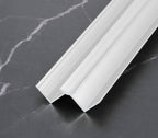 White 3mm aluminum inside corner trim profile angled on dark marble