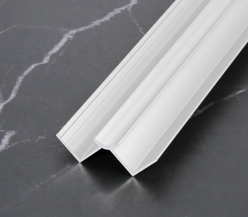 White 3mm aluminum inside corner trim profile angled on dark marble